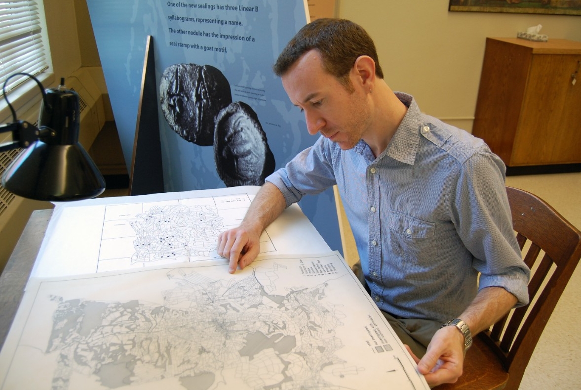 A student examines a book in a library.